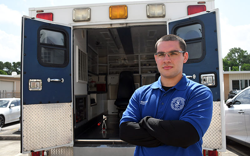 Michael Manthey standing outside an ambulance used for training at San Jacinto College